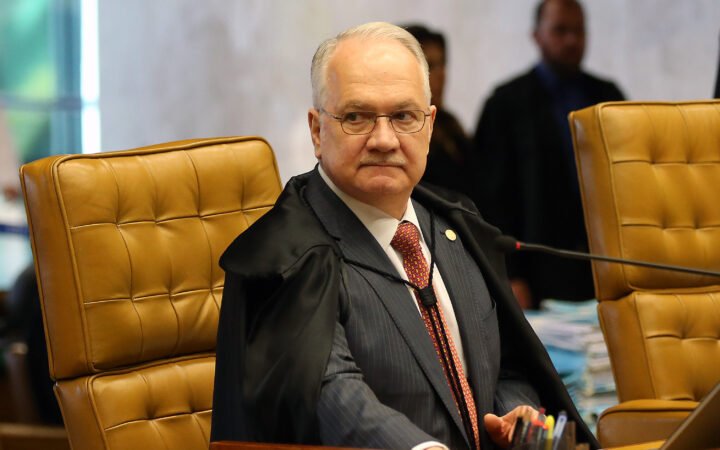 Edson Fachin de toga e óculos, sentado em cadeira do plenário do Supremo Tribunal Federal, em 2018.
